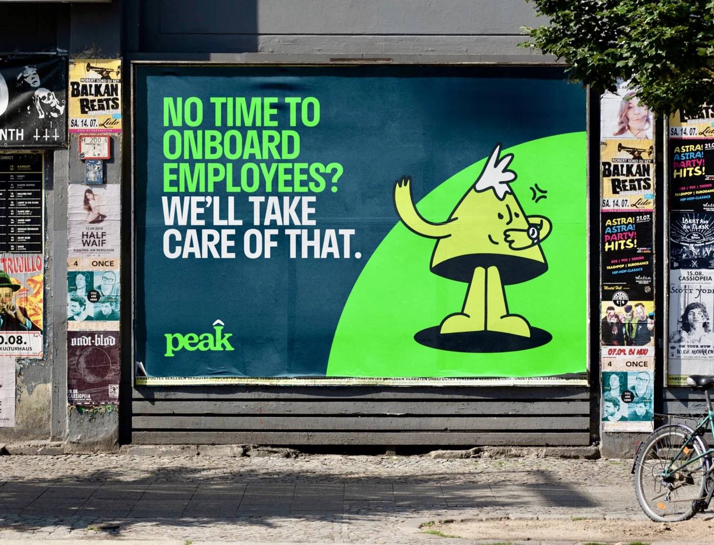 A Peak billboard on a European street reading 'No time to onboard employees? We'll take care of that.'